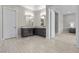 A bright bathroom features stylish vanity with mosaic tiles, adjacent to a doorway to a bedroom at 7477 Triple Knot Ct, Las Vegas, NV 89113