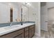 Bathroom with double sinks and mosaic tile backsplash at 7477 Triple Knot Ct, Las Vegas, NV 89113