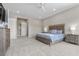 Spacious bedroom with a decorative bed frame, plush carpeting, and neutral color scheme at 7477 Triple Knot Ct, Las Vegas, NV 89113
