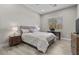Cozy bedroom featuring a comfortable bed, natural light, and a simple desk area at 7477 Triple Knot Ct, Las Vegas, NV 89113