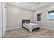 Bright bedroom features wood-look floors, a ceiling fan and natural light from two windows at 7477 Triple Knot Ct, Las Vegas, NV 89113