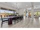 Open-concept dining room features a large dining table, modern chandelier and sliding glass doors at 7477 Triple Knot Ct, Las Vegas, NV 89113