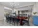 Open-concept dining room featuring a large table, modern chandelier, and seamless flow to the kitchen and living area at 7477 Triple Knot Ct, Las Vegas, NV 89113