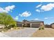 Attractive single-story home with a three-car garage, brick driveway, and landscaped front yard at 7477 Triple Knot Ct, Las Vegas, NV 89113