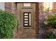 Beautiful front door with stone entryway and lush greenery at 7477 Triple Knot Ct, Las Vegas, NV 89113