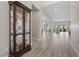 Long hallway leads to multiple living spaces and showcases elegant decor and neutral color palette at 7477 Triple Knot Ct, Las Vegas, NV 89113