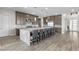 Well-appointed kitchen featuring a large island with bar seating, granite countertops and stainless appliances at 7477 Triple Knot Ct, Las Vegas, NV 89113