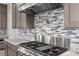 Modern kitchen showcasing stainless steel appliances, a stylish backsplash, and stone countertops at 7477 Triple Knot Ct, Las Vegas, NV 89113