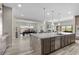 Spacious open kitchen and dining area featuring an oversized kitchen island and ample seating at 7477 Triple Knot Ct, Las Vegas, NV 89113