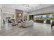 Bright living room with fireplace, tiled floors, recessed lights, and sliding glass doors to the outdoor patio and pool at 7477 Triple Knot Ct, Las Vegas, NV 89113