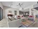 Spacious living room open to the kitchen featuring ample seating, modern lighting, and stylish decor at 7477 Triple Knot Ct, Las Vegas, NV 89113