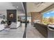 A gorgeous living room and covered patio are combined with a fireplace feature at 7477 Triple Knot Ct, Las Vegas, NV 89113