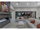 Modern living room with fireplace and sliding glass doors to a backyard pool at 7477 Triple Knot Ct, Las Vegas, NV 89113