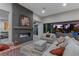 Stylish living room with a fireplace, comfortable seating, and seamless access to outdoor amenities at 7477 Triple Knot Ct, Las Vegas, NV 89113