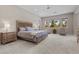 A spacious main bedroom features carpeted floors, a ceiling fan, and an abundance of natural light at 7477 Triple Knot Ct, Las Vegas, NV 89113