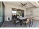 Enjoy outdoor dining on this covered patio with ceiling fan and view of the landscaped backyard at 7477 Triple Knot Ct, Las Vegas, NV 89113