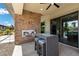 Inviting outdoor fireplace and bar area with modern design and comfortable seating for entertaining guests at 7477 Triple Knot Ct, Las Vegas, NV 89113