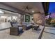 An outdoor patio features a fireplace, comfortable seating, and a view of the interior living spaces at 7477 Triple Knot Ct, Las Vegas, NV 89113