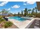 Beautiful backyard oasis featuring a pool, spa, lush landscaping, and lounge area at 7477 Triple Knot Ct, Las Vegas, NV 89113