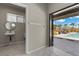 Bathroom, hooks, and pool view in a modern pool house design with a large door and outdoor furniture at 7477 Triple Knot Ct, Las Vegas, NV 89113