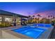 A backyard swimming pool features two spas, patio seating, and lush landscaping at 7477 Triple Knot Ct, Las Vegas, NV 89113