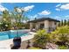 Inviting backyard oasis with a sparkling pool, jacuzzi, and cabana, perfect for relaxation and outdoor entertaining at 7477 Triple Knot Ct, Las Vegas, NV 89113