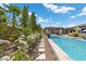 Captivating pool view with a hot tub and surrounding landscaping, offering a serene and refreshing retreat at 7477 Triple Knot Ct, Las Vegas, NV 89113