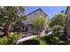 Inviting backyard with lush greenery, a charming patio, and pergola perfect for outdoor relaxation and dining at 7788 Ebro Valley Ct, Las Vegas, NV 89113
