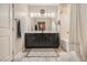 Well-lit bathroom with double sink vanity, full mirror, stylish cabinets, and combined tub and shower at 7788 Ebro Valley Ct, Las Vegas, NV 89113