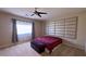 Comfortable bedroom with ceiling fan and a decorative upholstered headboard for a calm, cozy retreat at 7788 Ebro Valley Ct, Las Vegas, NV 89113