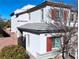 Charming two-story home featuring a stucco exterior, red shutters, and a well-maintained front yard at 7788 Ebro Valley Ct, Las Vegas, NV 89113