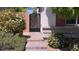 Beautiful walkway leading to an ornate gate and the main entrance with flowering bushes at 7788 Ebro Valley Ct, Las Vegas, NV 89113