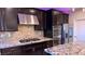 Gourmet kitchen with stainless steel appliances, granite countertops, and custom backsplash at 7788 Ebro Valley Ct, Las Vegas, NV 89113