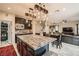 Bright kitchen featuring a granite island, wooden cabinets, and an open floorplan at 7788 Ebro Valley Ct, Las Vegas, NV 89113