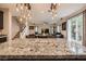 Open floorplan featuring a granite island, dining table, and sliding doors to the patio at 7788 Ebro Valley Ct, Las Vegas, NV 89113