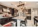 Modern kitchen with stainless steel appliances, granite countertops, and dark wood cabinetry at 7788 Ebro Valley Ct, Las Vegas, NV 89113