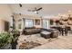 Cozy living room featuring a leather sectional, ceiling fan, and an open layout at 7788 Ebro Valley Ct, Las Vegas, NV 89113