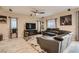 Comfortable living room with a leather sectional, entertainment center, and decorative floral rug at 7788 Ebro Valley Ct, Las Vegas, NV 89113