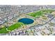 Aerial view of Primary-planned community featuring a central lake, green spaces, and surrounding residential neighborhoods at 789 Goodman Cove St, Henderson, NV 89011