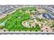 An aerial view of a vibrant community park featuring green spaces, walking paths, and recreational facilities at 789 Goodman Cove St, Henderson, NV 89011