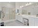 Bright bathroom with double vanity, walk-in shower, and white cabinetry at 789 Goodman Cove St, Henderson, NV 89011