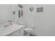 Bathroom with coastal decor, toilet, and sink with modern fixtures at 789 Goodman Cove St, Henderson, NV 89011