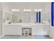 Bright bathroom with double vanity, white cabinetry, and large mirrors at 789 Goodman Cove St, Henderson, NV 89011