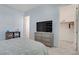 Comfortable bedroom with soft blue color scheme, television, and nearby closet at 789 Goodman Cove St, Henderson, NV 89011