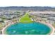 A picturesque community lake surrounded by green spaces, walking trails, and residential homes, creating a serene environment at 789 Goodman Cove St, Henderson, NV 89011