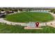 Expansive community park with a large grassy area, walking paths, benches, and decorative signage, perfect for outdoor recreation at 789 Goodman Cove St, Henderson, NV 89011
