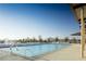 Relaxing community pool with lounge chairs, shaded seating, and clear blue water, creating an inviting space at 789 Goodman Cove St, Henderson, NV 89011