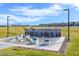 Outdoor fitness court featuring various exercise stations and equipment on a concrete pad with surrounding landscaping at 789 Goodman Cove St, Henderson, NV 89011