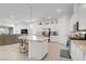 Open-concept kitchen with island featuring granite countertops, bar stool seating, and stainless steel appliances at 789 Goodman Cove St, Henderson, NV 89011