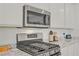 Updated kitchen with stainless steel appliances, gas range, and stone countertops at 789 Goodman Cove St, Henderson, NV 89011